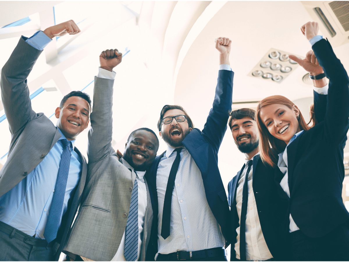Happy professionals celebrating team success